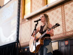 Abby Stewart performing with guitar