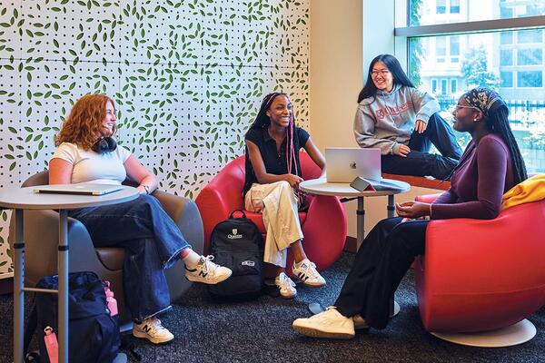 [four seated students chatting]