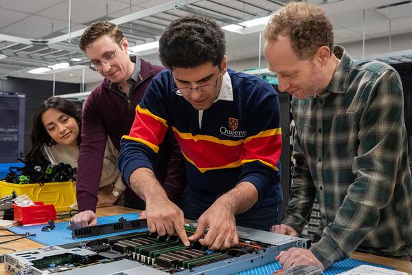 [researchers working with other team members watching]