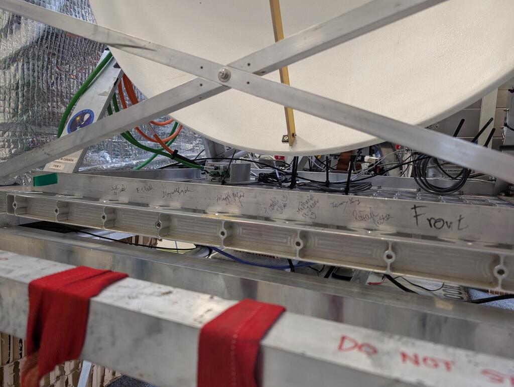 An aluminum frame with the signatures of the BVEX team in black ink, and also the label "Front"