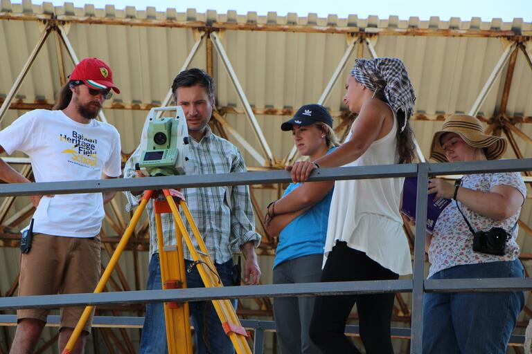 Dr. George Bevan teaching students how to use surveying tools.