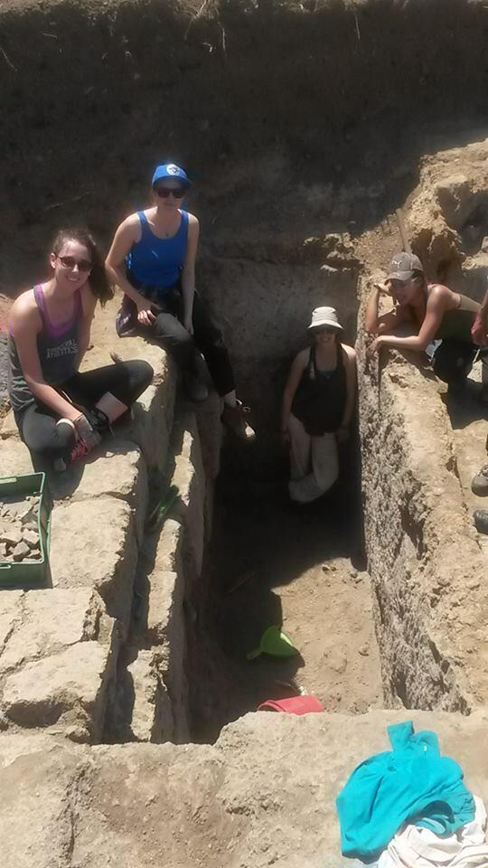 Students posing in and around a trench on the Caere dig site in 2016.