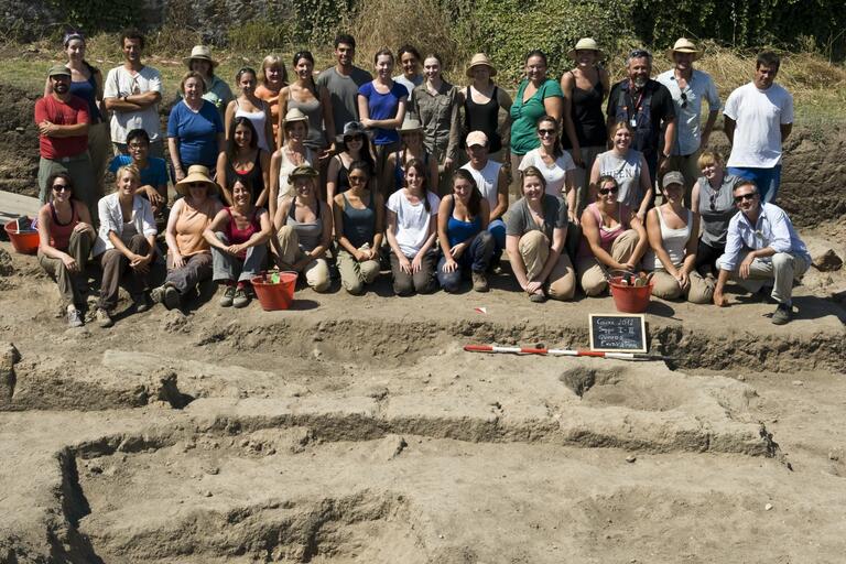 Photograph of the Caere dig team from 2012, posing amongst the excavation.
