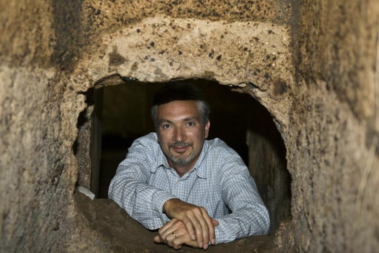 Photograph of Dr. Fabio Colivicchi posing within the ruins found at Caere.