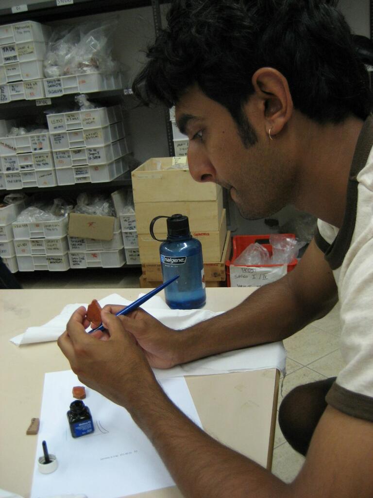 Student learning how to re-attach pieces of pottery during Matera field study.