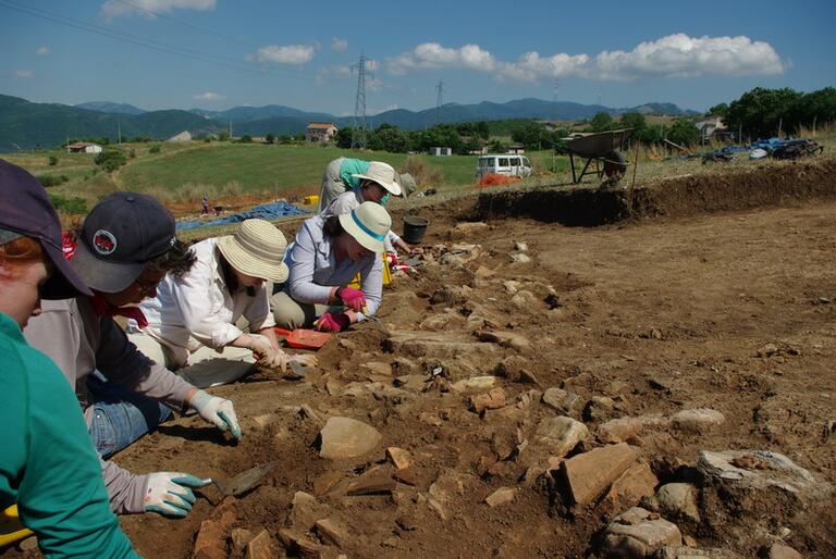 Students working carefully at Matera dig site.