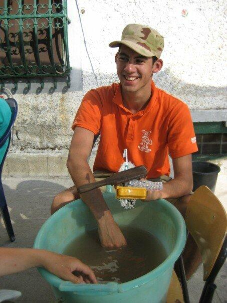 Student washing pottery sherds at Matera excavation.