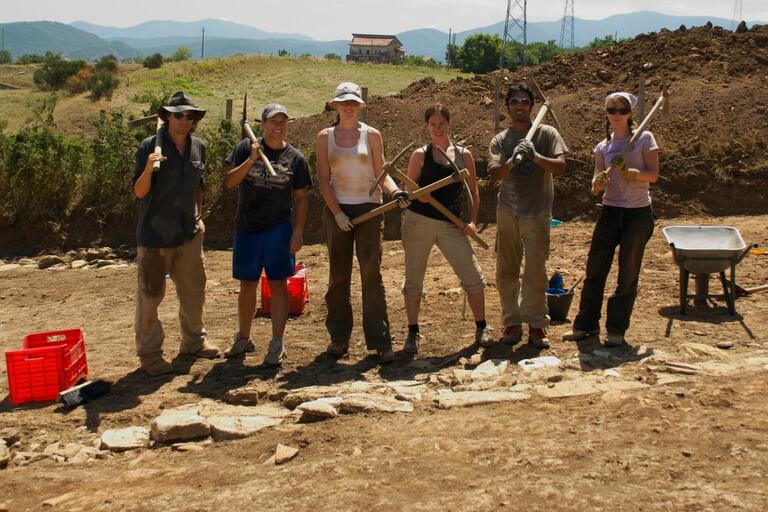 Group of students posing with dig tools at Matera.