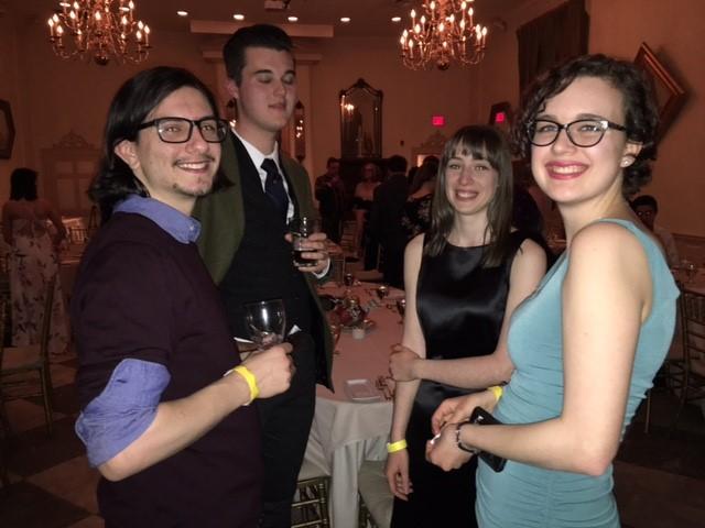 Four students standing in a circle having a conversation