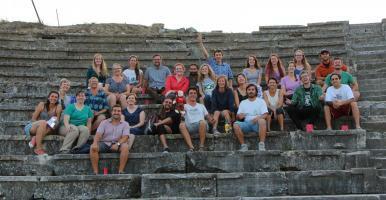 Group shot of Stobi excavation group posing on some stone steps.