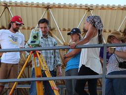 Dr. George Bevan teaching students how to use surveying tools.