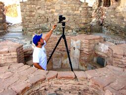 Student setting up to take careful photographs at Stobi excavation site.
