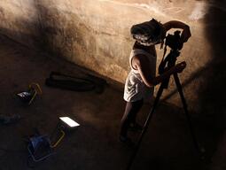 Student setting up to take photographs of an underground chamber at Stobi excavation site. 
