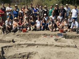 Photograph of the Caere dig team from 2012, posing amongst the excavation.