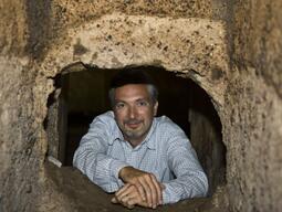 Photograph of Dr. Fabio Colivicchi posing within the ruins found at Caere.