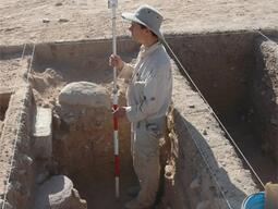 Student taking elevation measurements at Humayma.