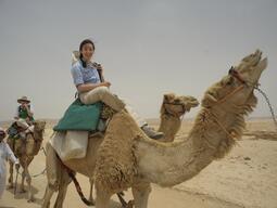 Students riding on camels in Jordan.