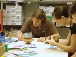 Students learning to draw images of ancient pottery they find during excavations.