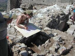 Student graphing dig locations at Matera excavation site.