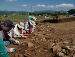 Students working carefully at Matera dig site.