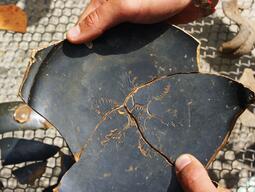 Broken pottery sherds pieced together.