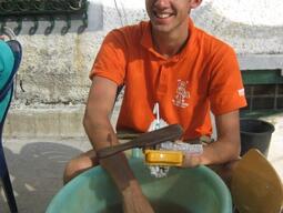 Student washing pottery sherds at Matera excavation.