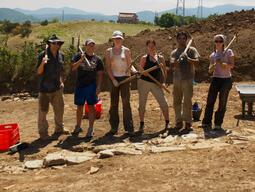 Group of students posing with dig tools at Matera.