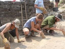 Students carefully sweeping during Stobi excavation.