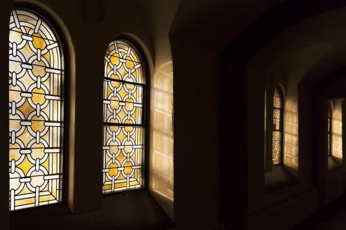 Photograph of Stained Glass Windows in Grant Hall, from the inside with sun shining through