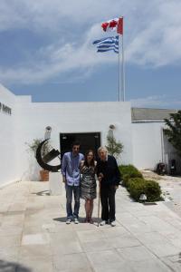 Three people standing outside of a building