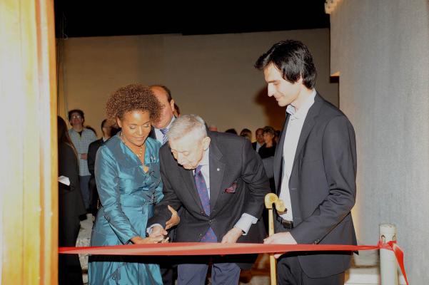 Three people looking at a piece of paper, one is writing
