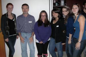 Six people standing and smiling for a photo