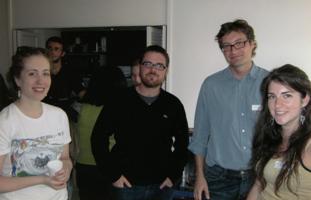 Four people standing in a circle