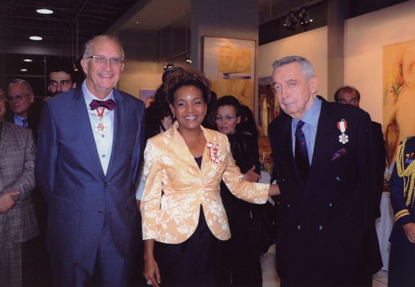 Three people smiling at an event