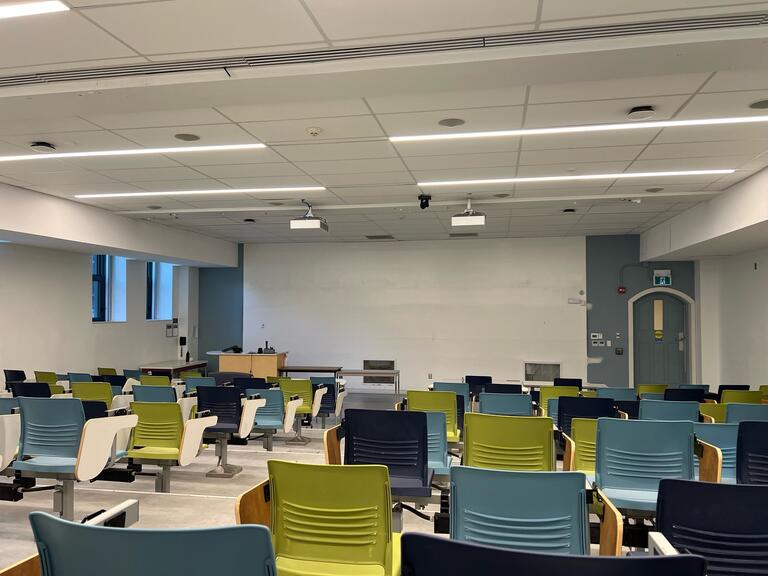 View of the classroom from a student seat near the rear of the room. 