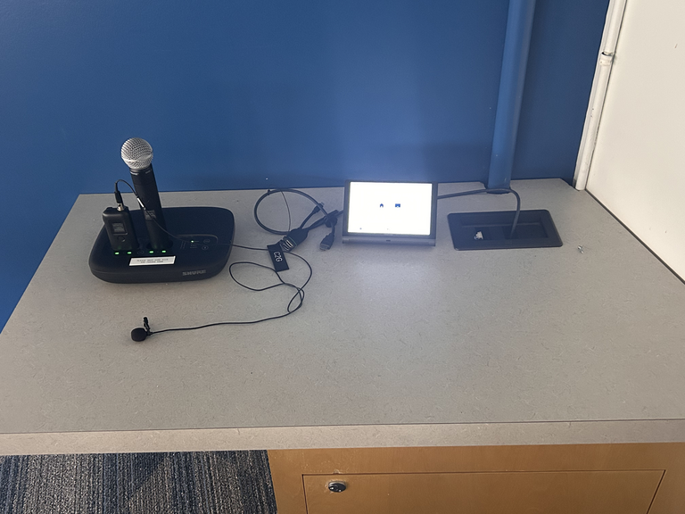 Top-down view of podium. Microphones on the left; touch panel control system on the right.