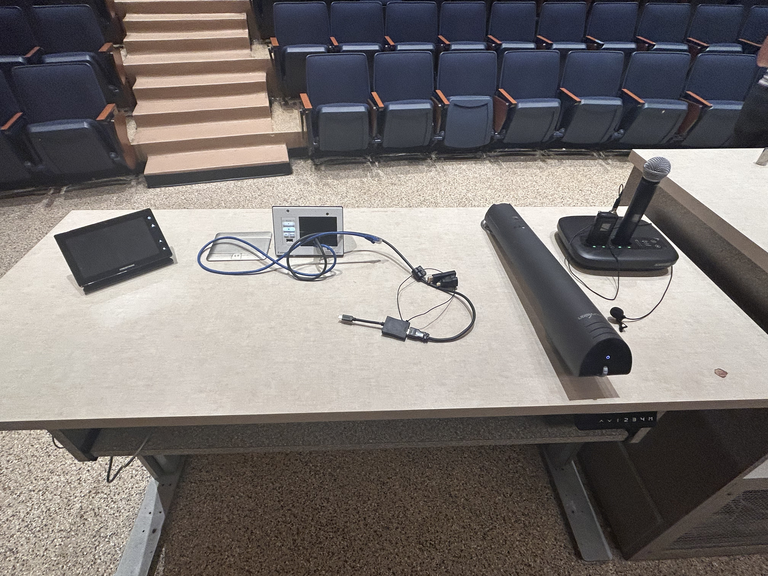 Top-down view of podium. Touch panel control system on the left; document camera at center; microphone on the right.