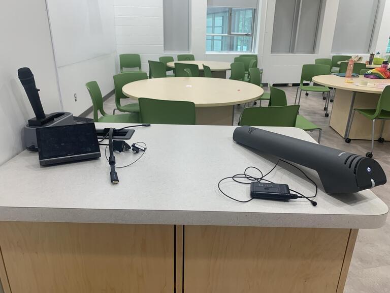 View of the classroom from the instructor’s podium. Desks are round and seat 7 students each, chairs can be arranged according the instructor’s preference. The entryway door is located behind the instructor’s podium. 