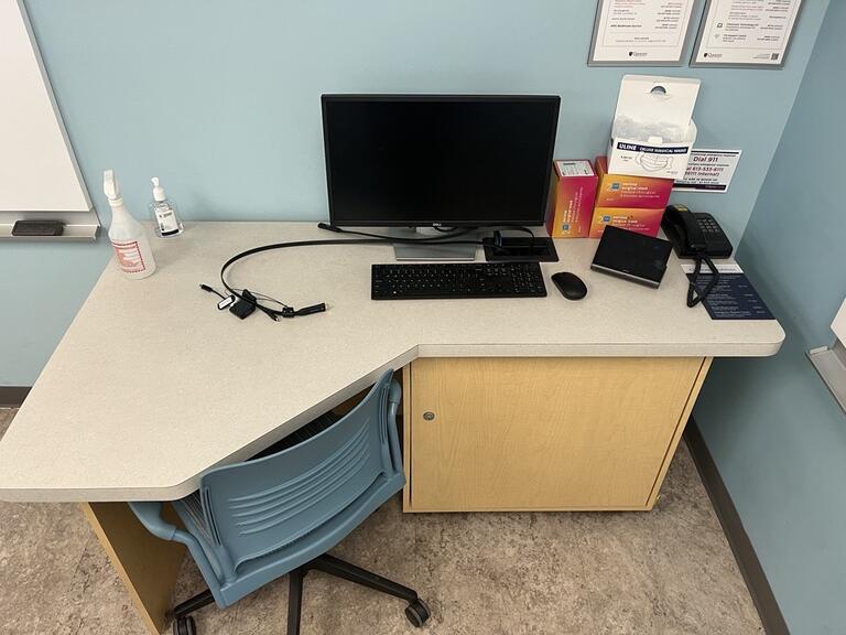 Image of the podium at the front of the classroom. This podium is not movable or height adjustable. A phone is located on the right side of the podium. This podium is not accessible. 