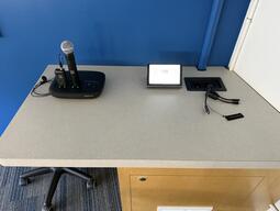 Top-down view of the podium. The podium has a set of display cables. The podium is not height adjustable or accessible.