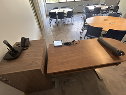 Microphones and telephone on the left; touch panel control system at center; document camera on the right.