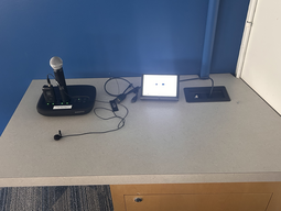Top-down view of podium. Microphones on the left; touch panel control system on the right.