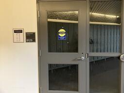 The door to room B129 in Botterell Hall is automatically controlled and has a handle on the right side. 