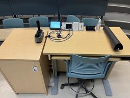 Top down view of podium. This image shows the height adjustable podium, equipped with a document camera, lecture capture and a set of microphones.