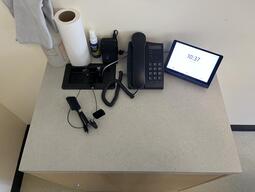 Top-down image of the podium. The podium is equipped with a set of connection cords to present media in the room.