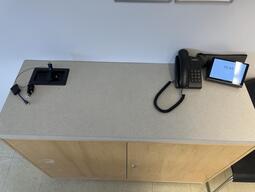 Top-down view of the podium, equipped with a set of connection cables to present media in the room.