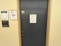 Image of the door to room 420 in Mackintosh Corry Hall. There is a doorknob on the left side of the door.