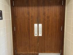 Entryway to room 301B in Stirling Hall. The double door has two pull handles in the center. There is no automatic operator.