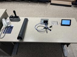 Top down view of the podium. The podium is height adjustable and comes equipped with lecture capture, a document camera as well as a set of microphones.