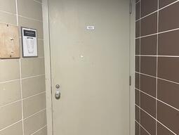 Entryway to room 401 in Stirling Hall. The door has a knob on the left side. There is no automatic operator.